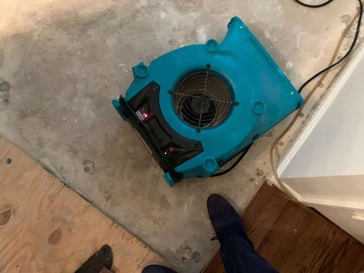 Air mover drying subfloor during Commercial Water Damage Restoration in Monett